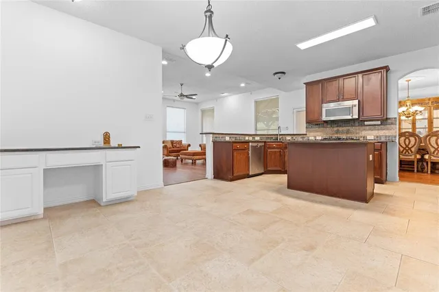 an aerial view of a house with swimming pool patio and lake view