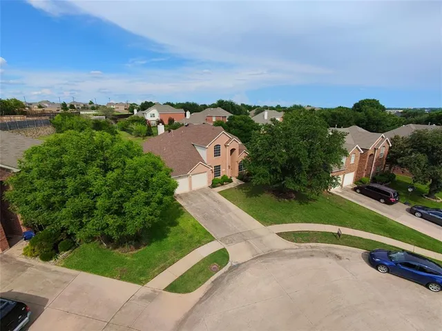 an aerial view of a house with a swimming pool