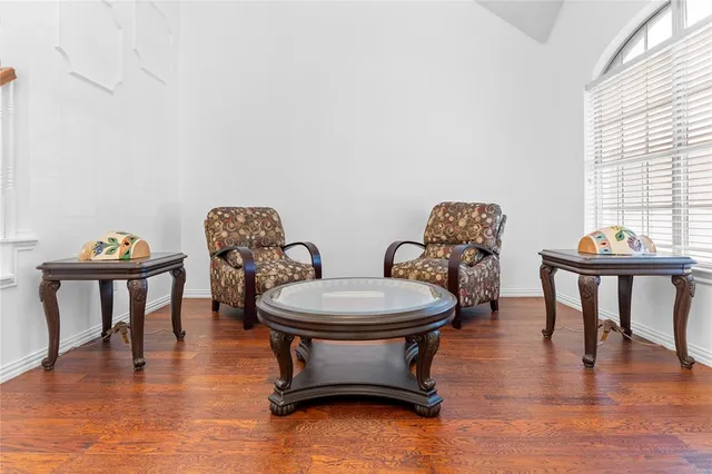 a room with furniture a window and a wooden floor