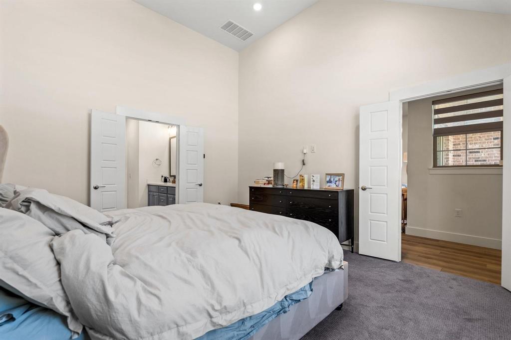 3781 Rochelle Court Prosper, TX 75078 - Photo 17 of 30 Carpeted bedroom featuring vaulted ceiling and connected bathroom