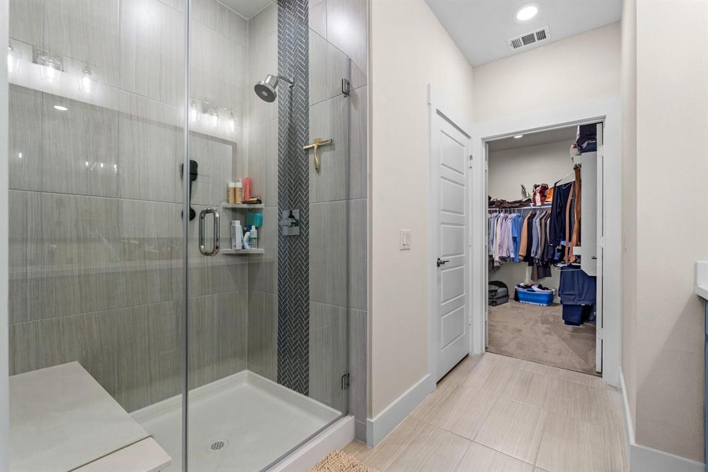 3781 Rochelle Court Prosper, TX 75078 - Photo 18 of 30 Bathroom with vanity, a stall shower, a spacious closet, and light tile patterned floors