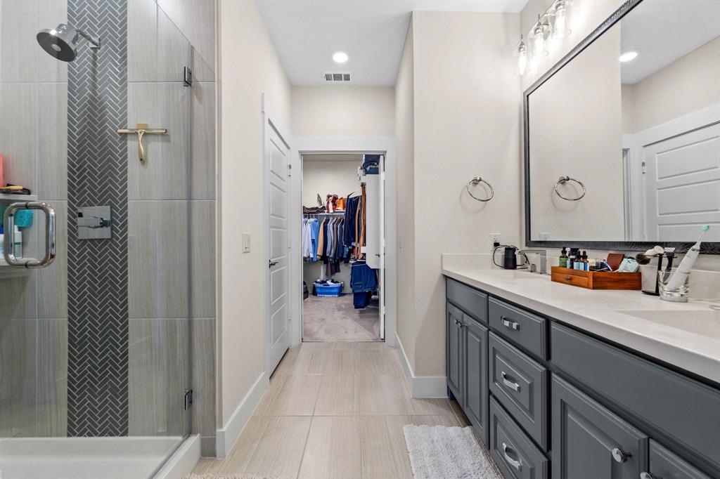 3781 Rochelle Court Prosper, TX 75078 - Photo 19 of 30 Bathroom with double vanity, a shower stall, and a spacious closet