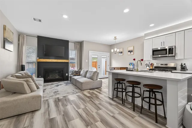 a living room with furniture a fireplace and a flat screen tv