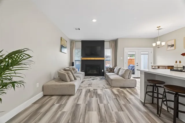 a living room with fireplace furniture and a wooden floor
