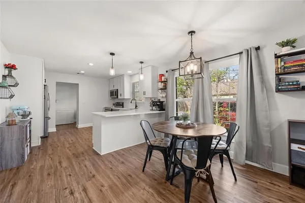 a view of a dining room with furniture window and wooden floor