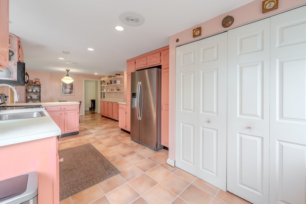 75 Ridge Street Arlington, MA 02474 - Photo 11 of 33 a large white kitchen with a sink and refrigerator