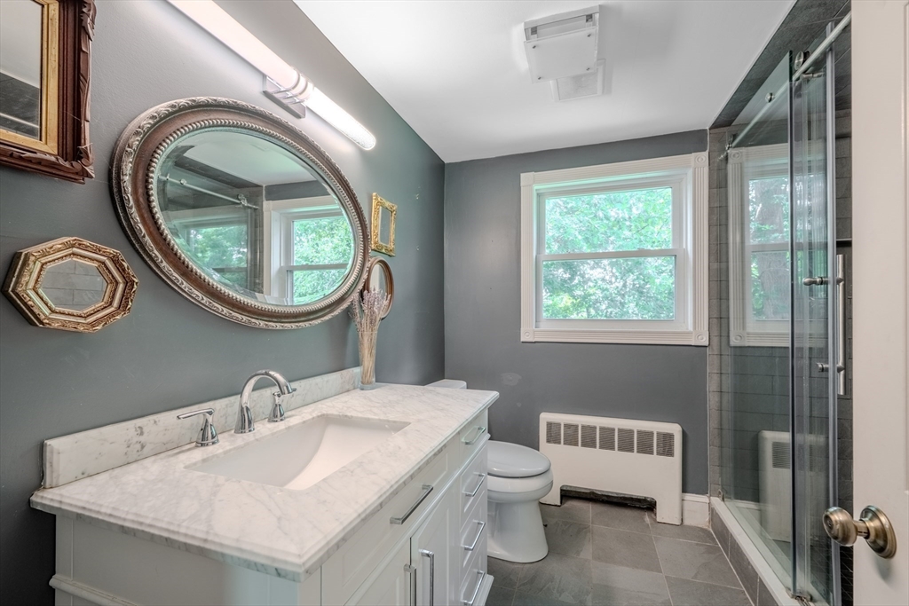 75 Ridge Street Arlington, MA 02474 - Photo 13 of 33 a bathroom with a toilet a sink and a mirror
