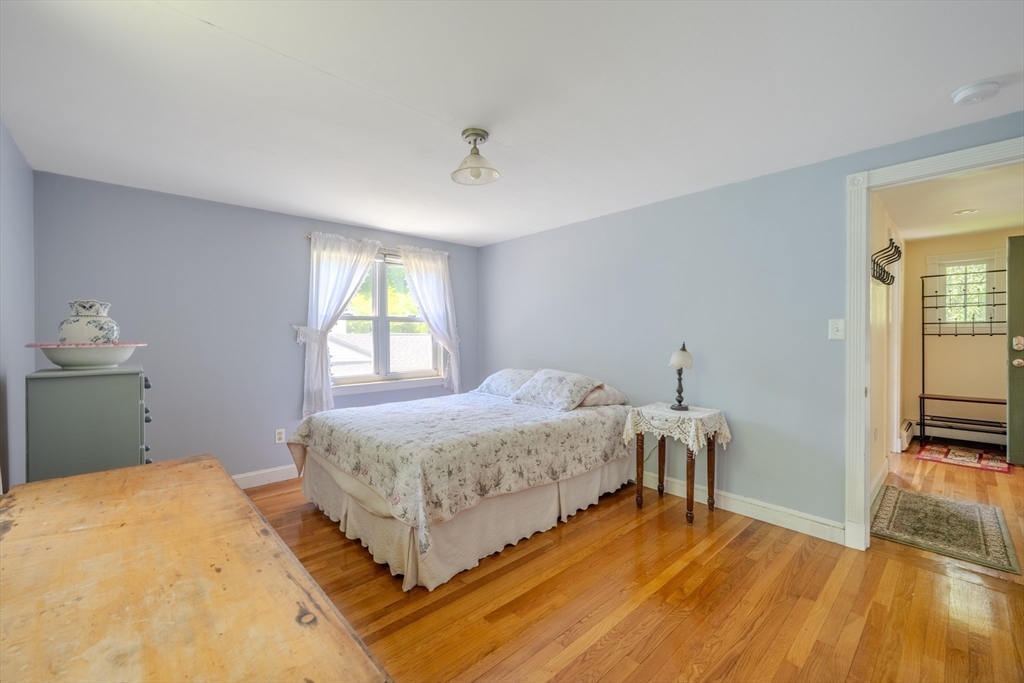 75 Ridge Street Arlington, MA 02474 - Photo 16 of 33 a bedroom with a bed and wooden floor