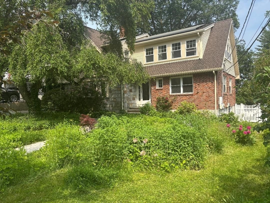 75 Ridge Street Arlington, MA 02474 - Photo 2 of 33 a front view of a house with garden