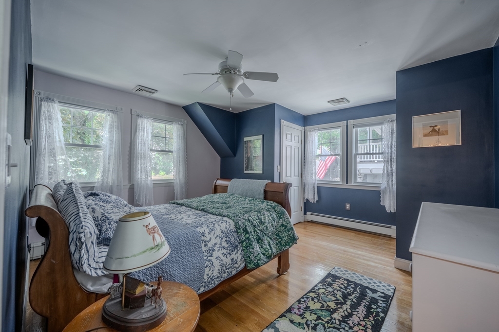 75 Ridge Street Arlington, MA 02474 - Photo 21 of 33 a bedroom with a bed and dresser with mirror