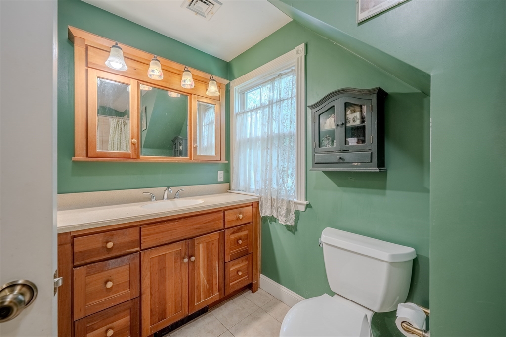 75 Ridge Street Arlington, MA 02474 - Photo 22 of 33 a bathroom with a toilet sink and mirror