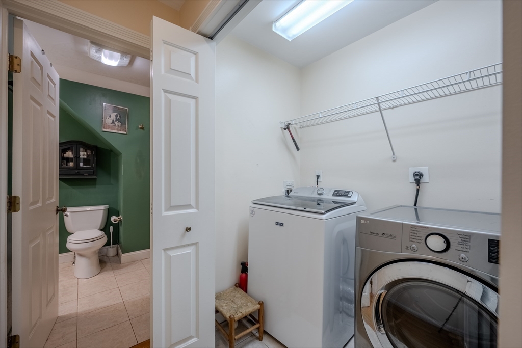 75 Ridge Street Arlington, MA 02474 - Photo 23 of 33 a view of a storage & utility room with sink dryer and washer