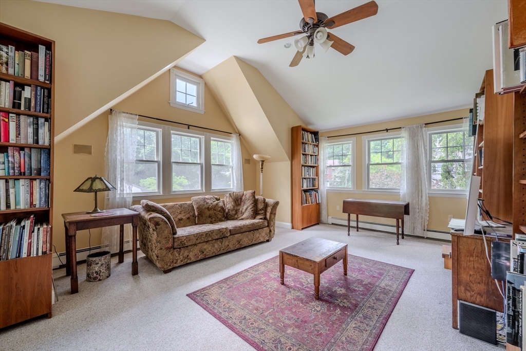 75 Ridge Street Arlington, MA 02474 - Photo 24 of 33 a living room with furniture a bookshelf and a window