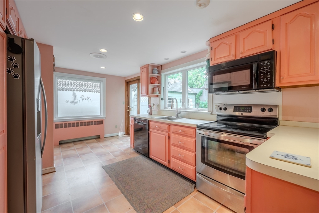 75 Ridge Street Arlington, MA 02474 - Photo 9 of 33 a kitchen with stainless steel appliances granite countertop a stove a sink and a refrigerator