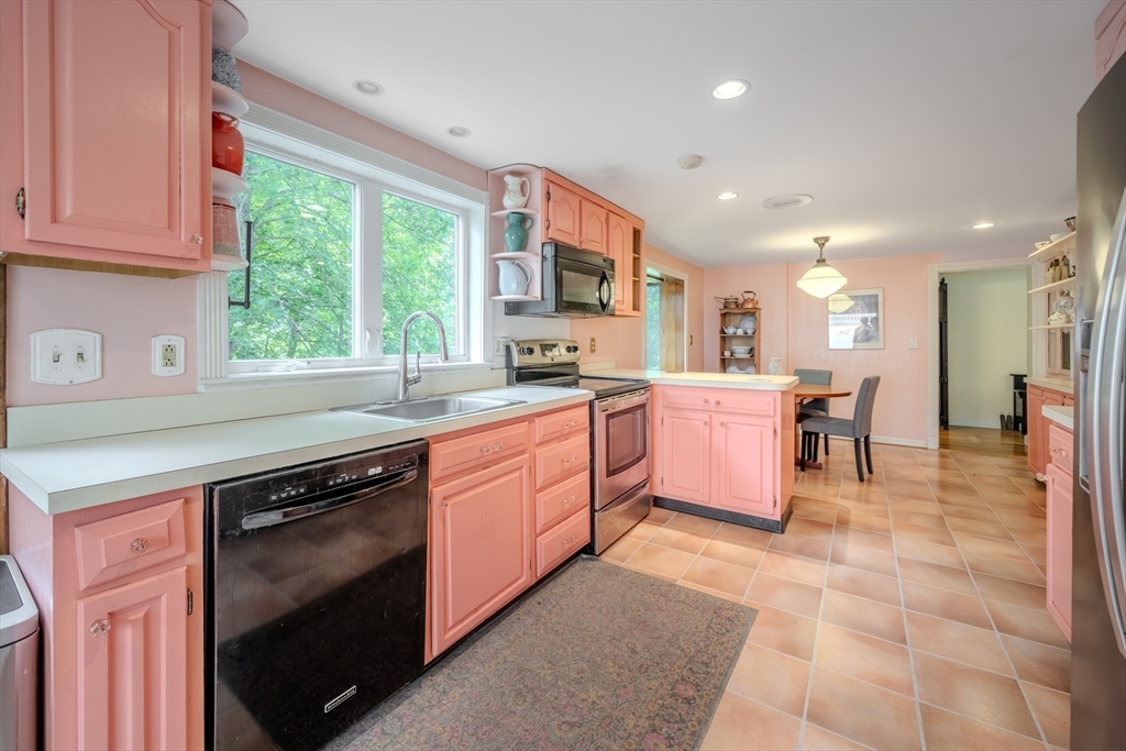 75 Ridge Street Arlington, MA 02474 - Photo 10 of 33 a kitchen with a stove sink and cabinets