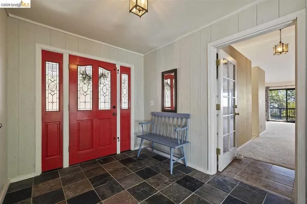 a view of a hallway with wooden floor and windows