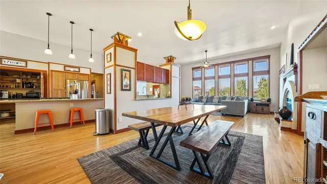 a living room with furniture a rug and a floor to ceiling window