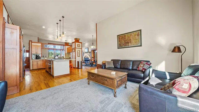 a living room with furniture and kitchen view