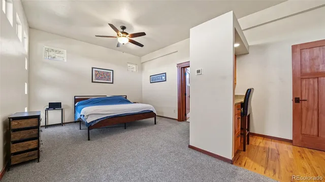 a spacious bedroom with a bed and a chandelier