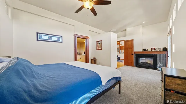 a spacious bedroom with a bed and a fireplace