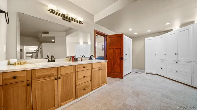a large bathroom with a large mirror vanity and shower