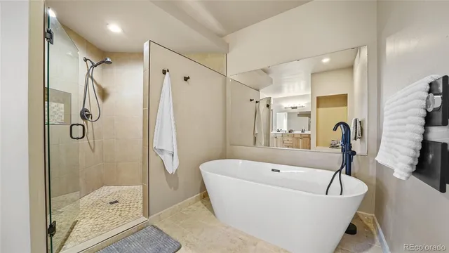 a bathroom with a bathtub and a shower