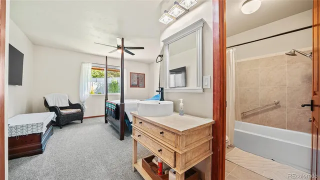 a en suite spacious bathroom with a tub sink and mirror