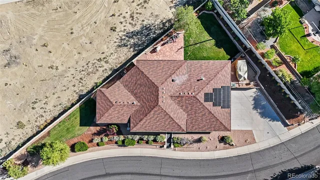 an aerial view of residential houses with outdoor space and seating