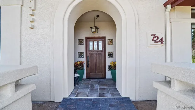 a view of a hallway with wooden floor and entryway