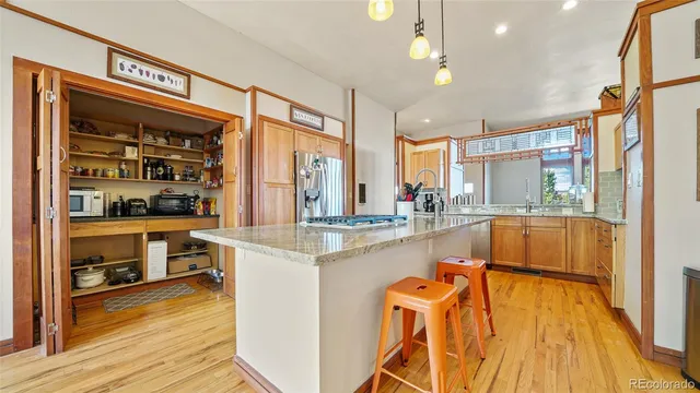 a kitchen with counter top space and wooden floor