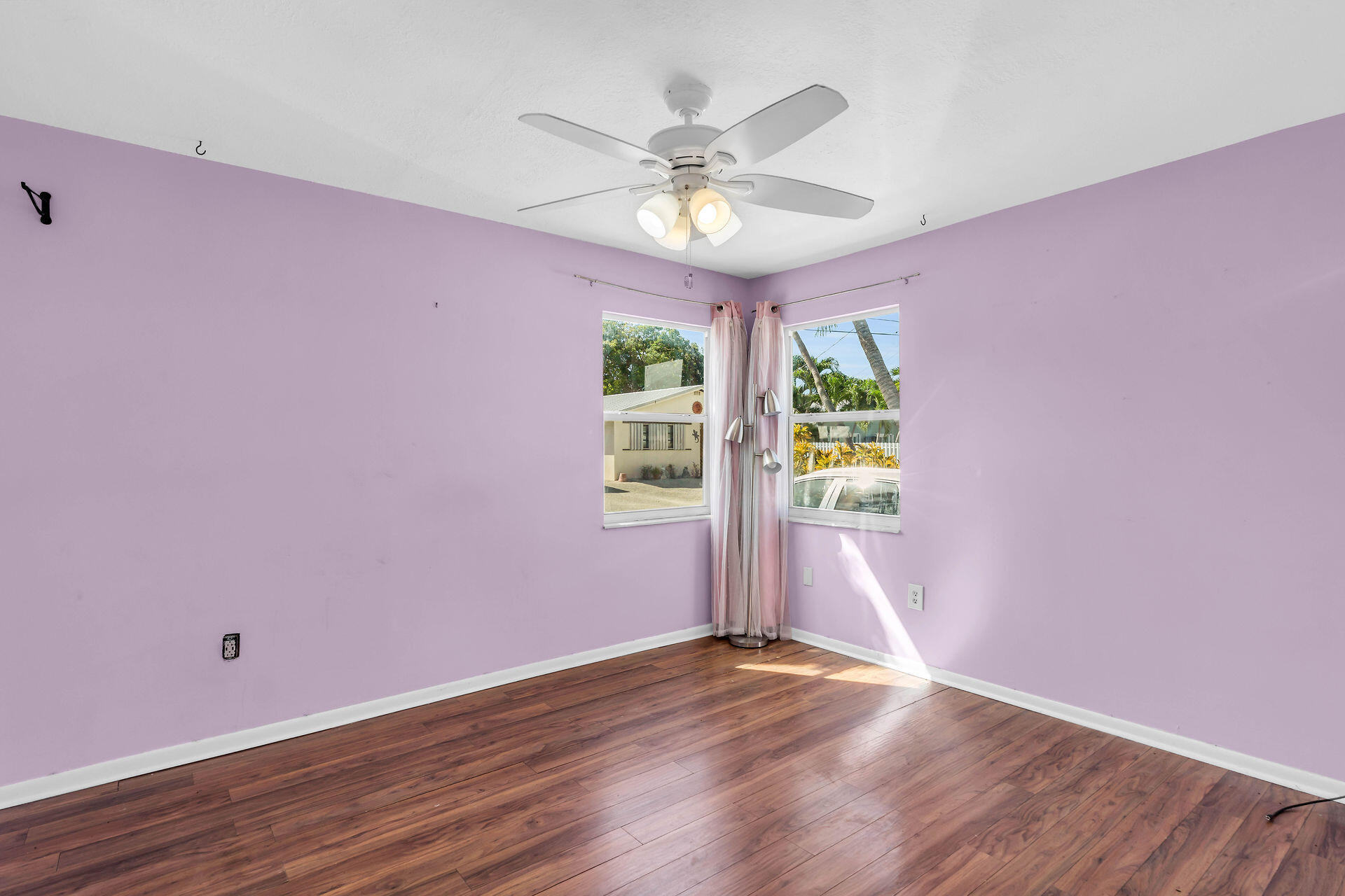 37 Orange Drive Key Largo, FL 33037 - Photo 12 of 32 a view of an empty room with wooden floor and a window