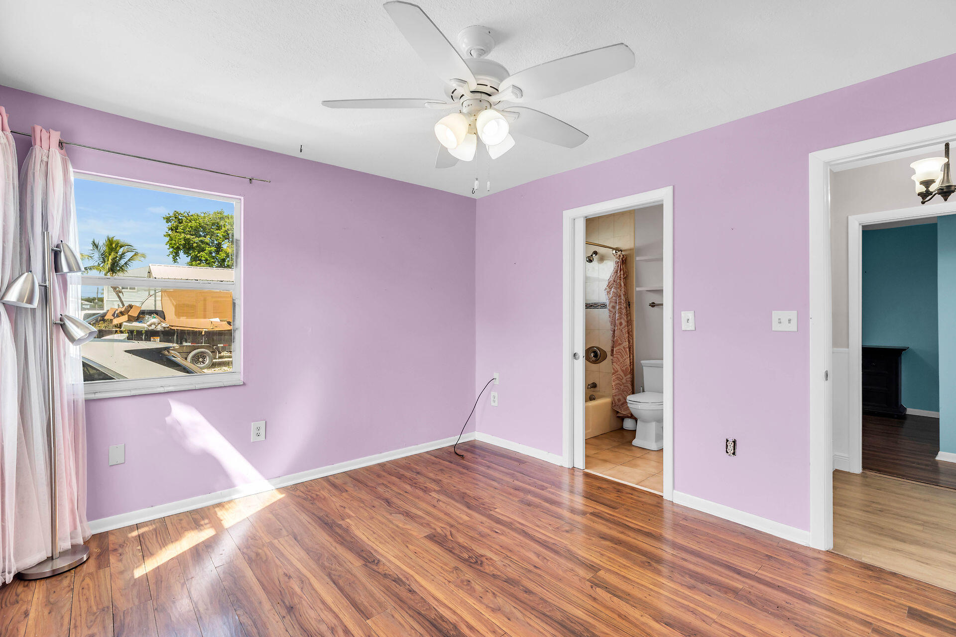 37 Orange Drive Key Largo, FL 33037 - Photo 13 of 32 a view of an empty room with wooden floor and a ceiling fan