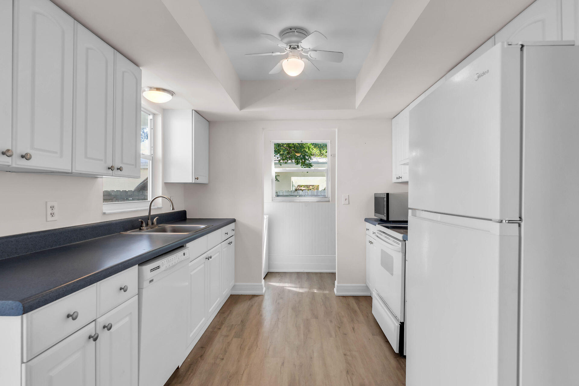 37 Orange Drive Key Largo, FL 33037 - Photo 6 of 32 a kitchen with a sink a refrigerator and cabinets