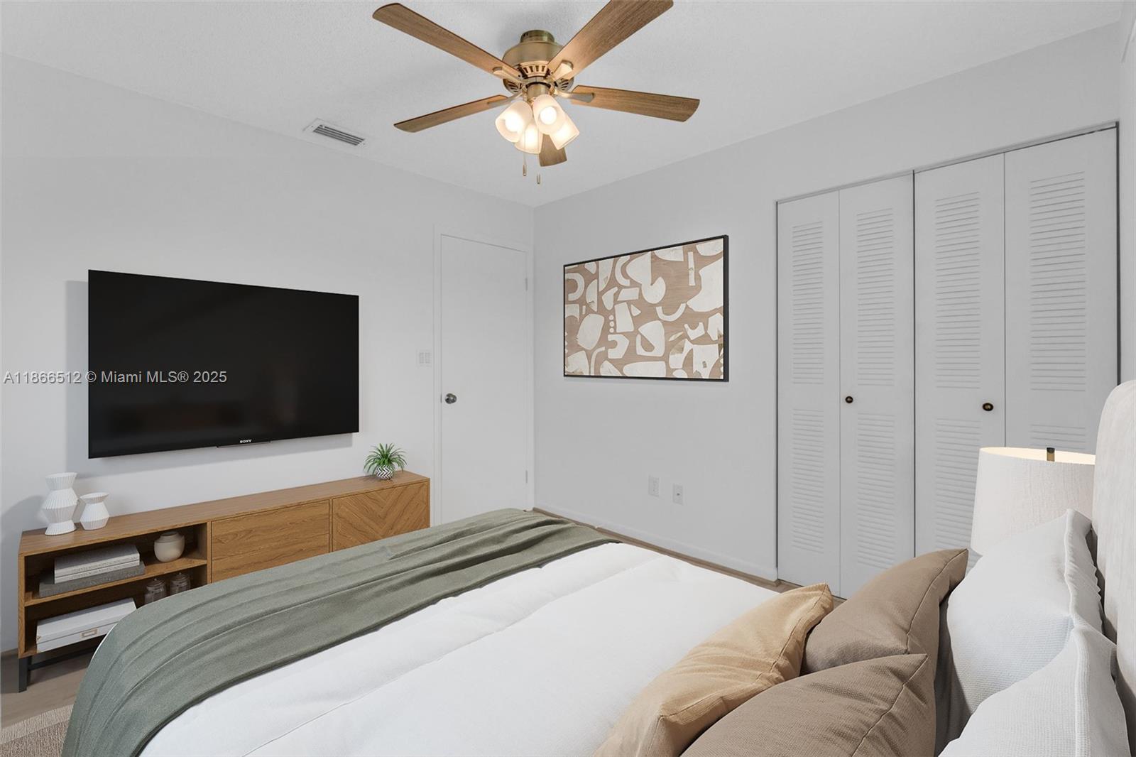13440 Southwest 81st Street Miami, FL 33183 - Photo 18 of 23 a bedroom with a bed and a flat screen tv