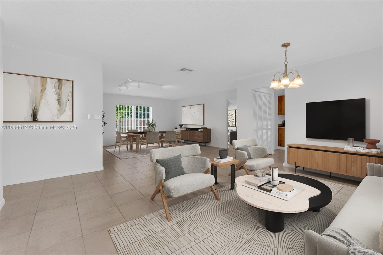 13440 Southwest 81st Street Miami, FL 33183 - Photo 2 of 23 a living room with furniture a flat screen tv and a dining table with a kitchen view