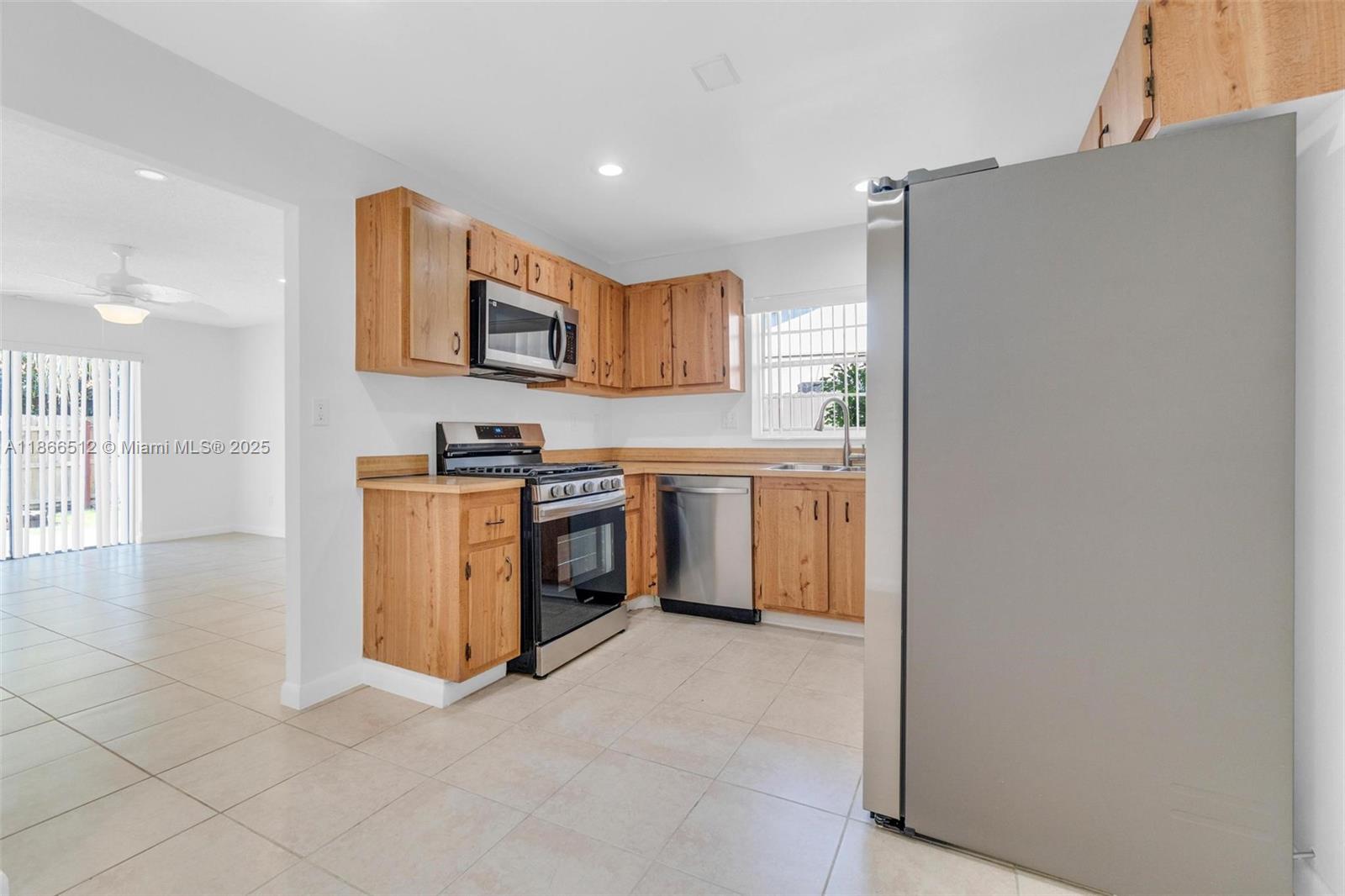 13440 Southwest 81st Street Miami, FL 33183 - Photo 5 of 23 a kitchen with stainless steel appliances granite countertop a stove a sink and a refrigerator