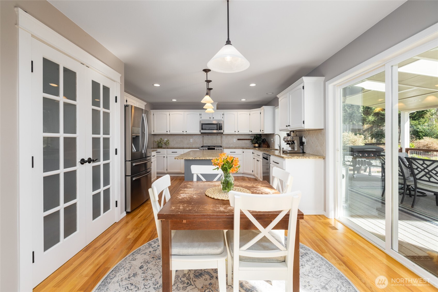 1014 South 38th Place Mount Vernon, WA 98274 - Photo 12 of 39 a view of a kitchen with kitchen island dining table and stainless steel appliances