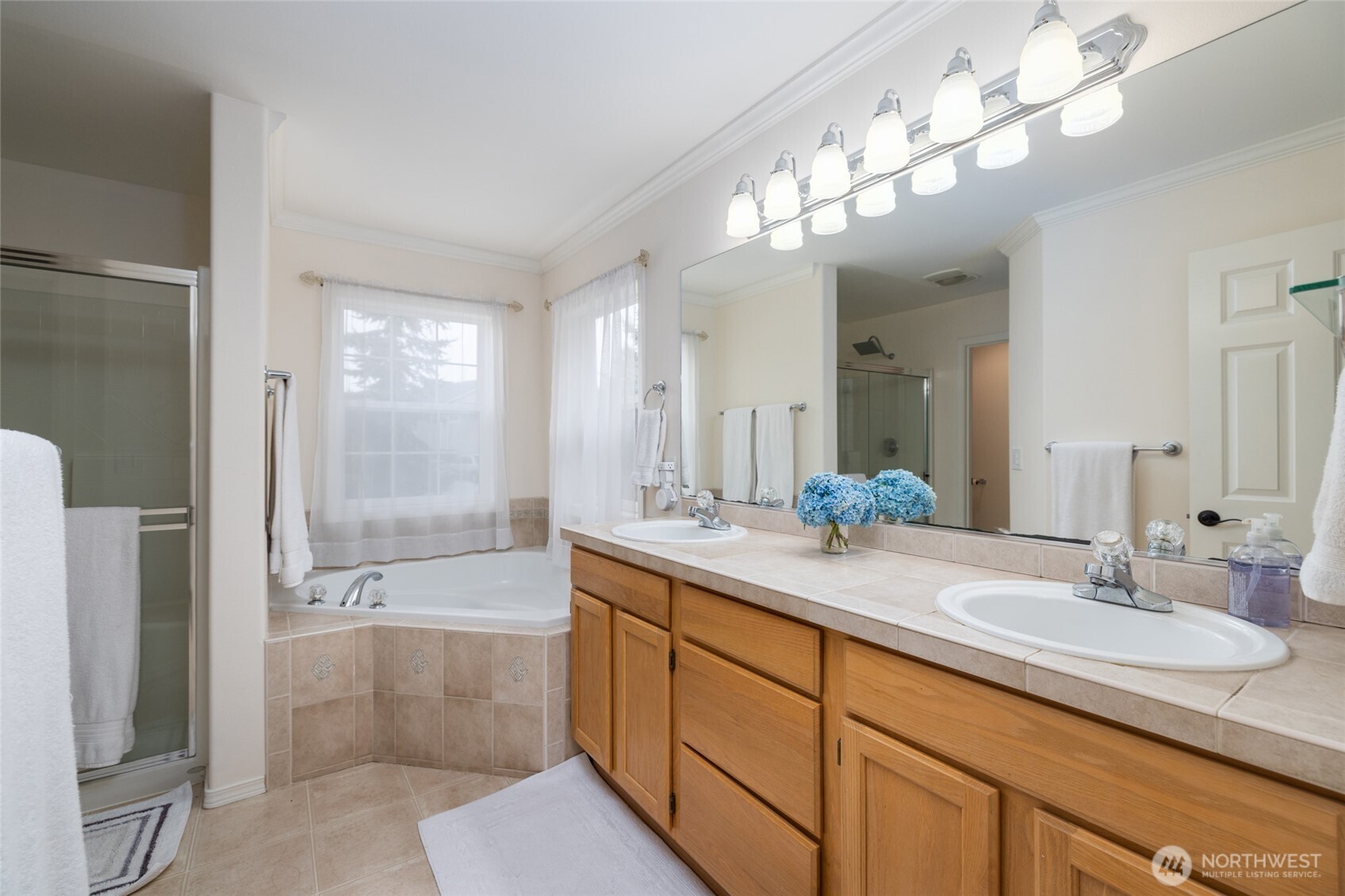 1014 South 38th Place Mount Vernon, WA 98274 - Photo 20 of 39 a spacious bathroom with a granite countertop sink a toilet a mirror and shower