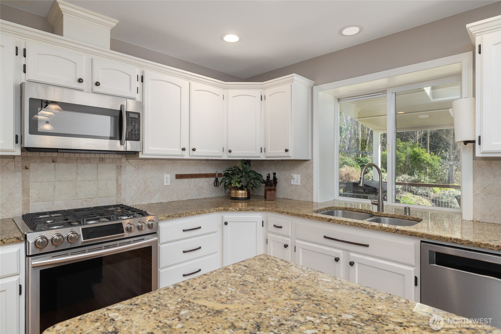 1014 South 38th Place Mount Vernon, WA 98274 - Photo 8 of 39 a kitchen with stainless steel appliances granite countertop white cabinets granite counter tops and a window
