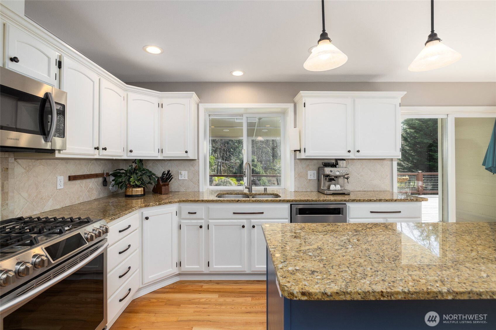 1014 South 38th Place Mount Vernon, WA 98274 - Photo 9 of 39 a kitchen with granite countertop a stove sink and cabinets