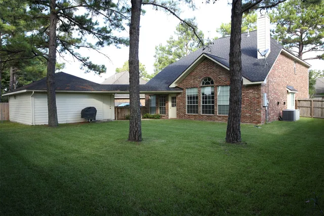 a front view of a house with a garden and yard