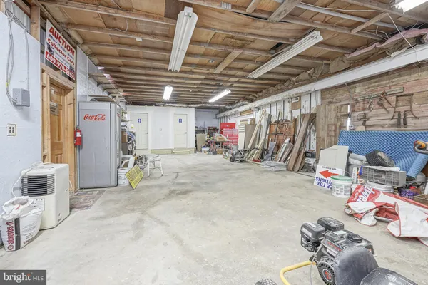 a view of a workspace with furniture and a kitchen