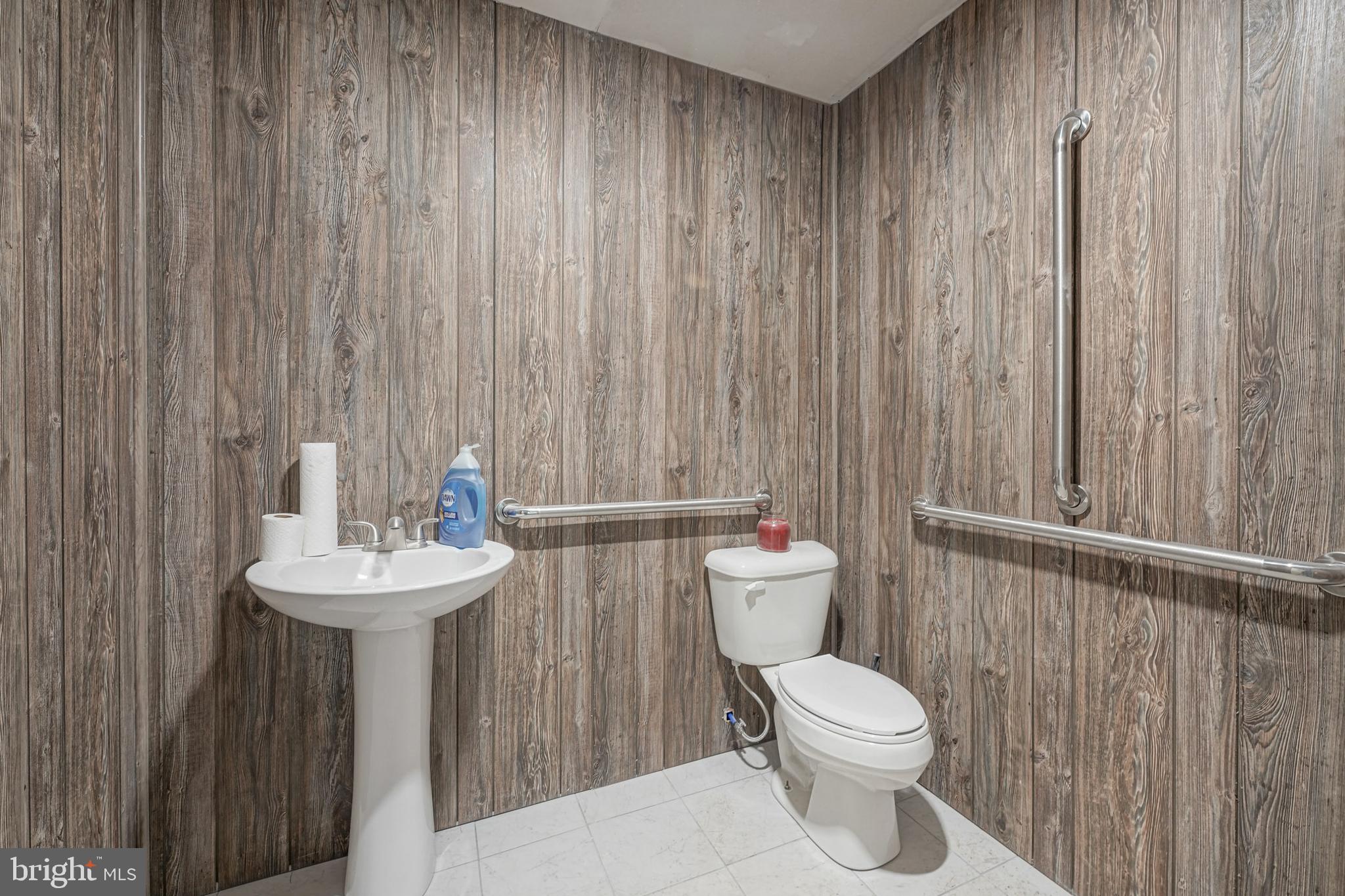461 Three Bridge Road Newfield, NJ 08344 - Photo 26 of 30 a bathroom with a toilet a sink and a mirror