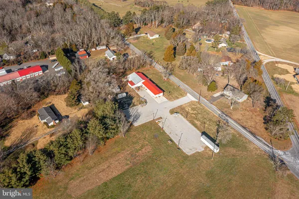 an aerial view of a house with a yard and mountain
