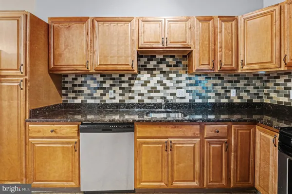 a kitchen with stainless steel appliances granite countertop a sink and cabinets