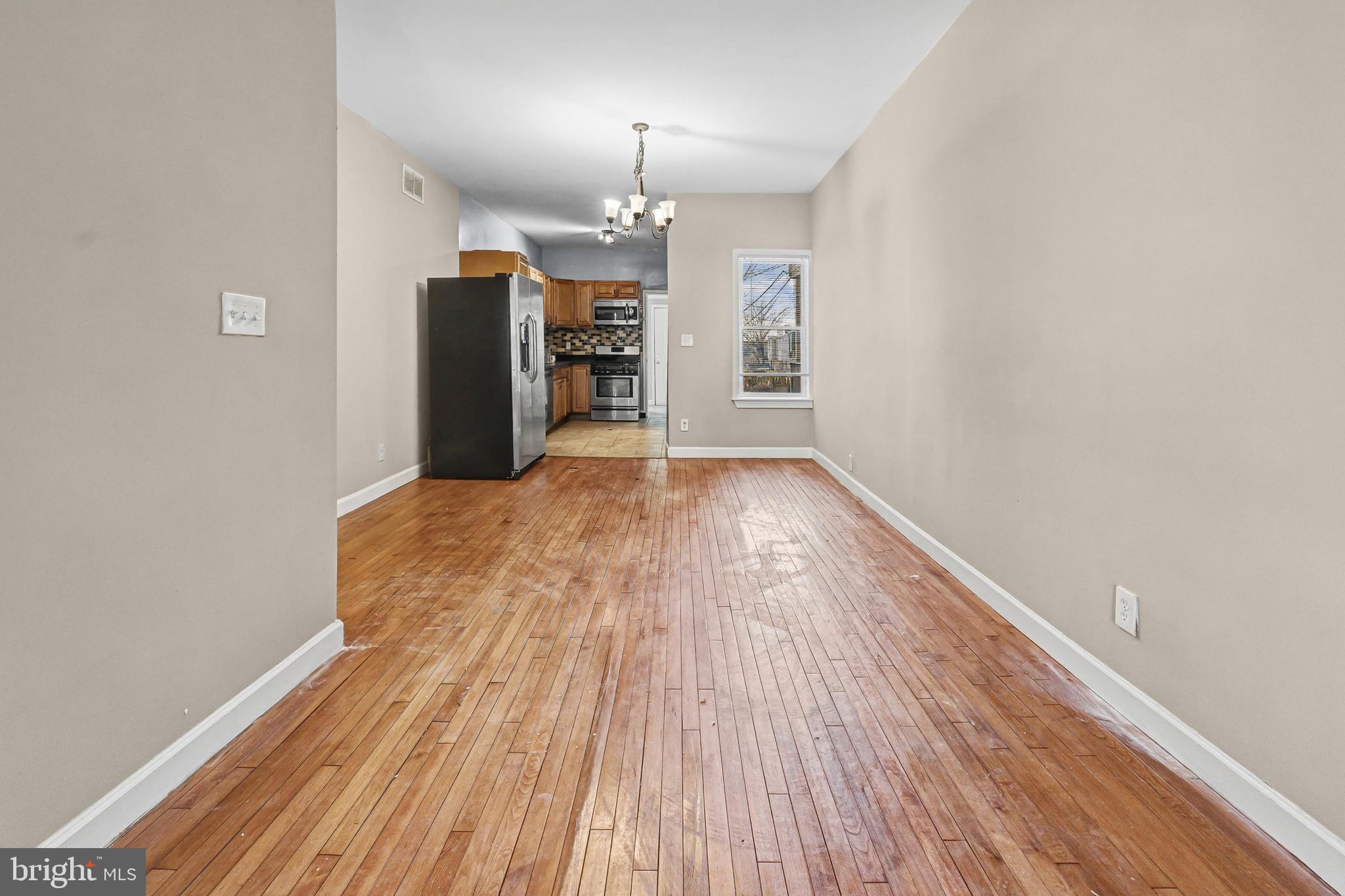 407 West 28th Street Baltimore, MD 21211 - Photo 7 of 30 wooden floor in an empty room with a window