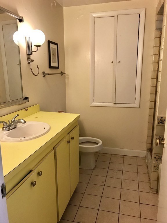 43-43A Grove Street, Unit 2 Boston, MA 02114 - Photo 6 of 6 a bathroom with a sink a toilet and mirror
