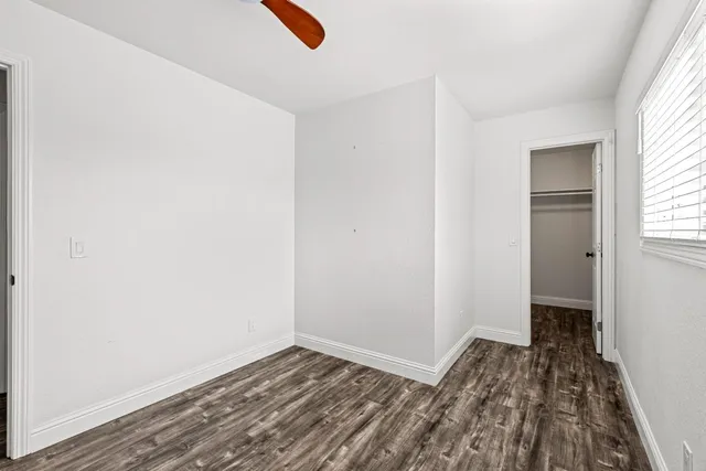 a bathroom with a granite countertop sink a toilet and a bathtub