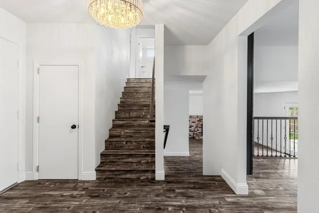 a kitchen view with stainless steel appliances kitchen island granite countertop a refrigerator and a sink