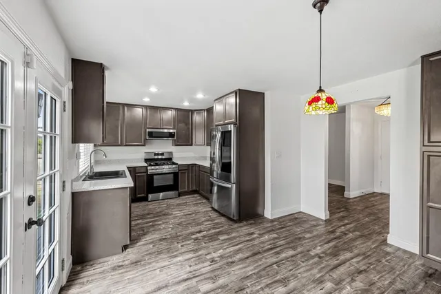 a view of a hallway with wooden floor